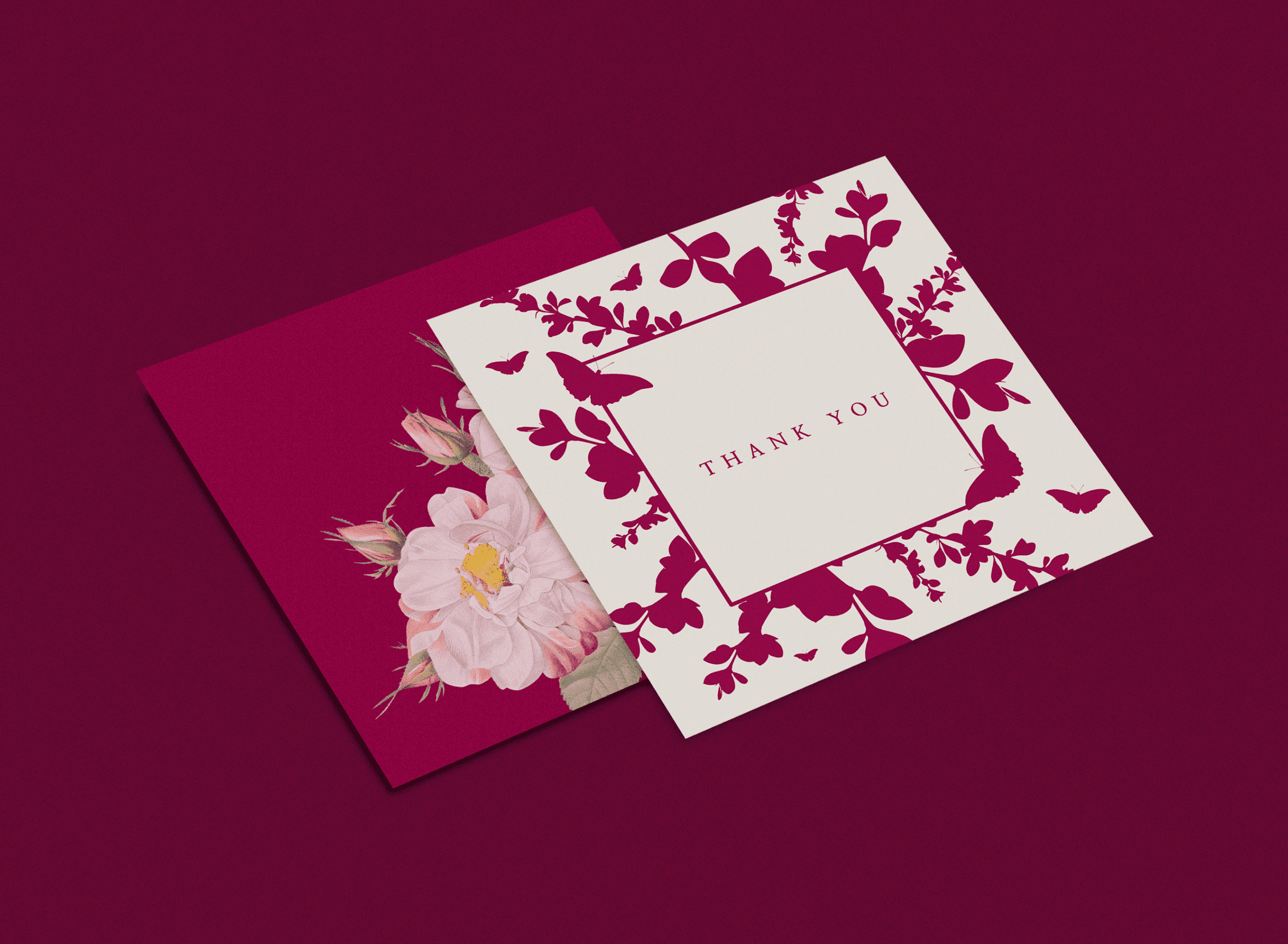 Two cards with flowers on a dark pink background
