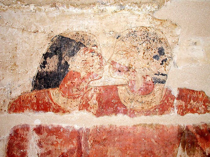 Two Egyptian men rubbing their noses.