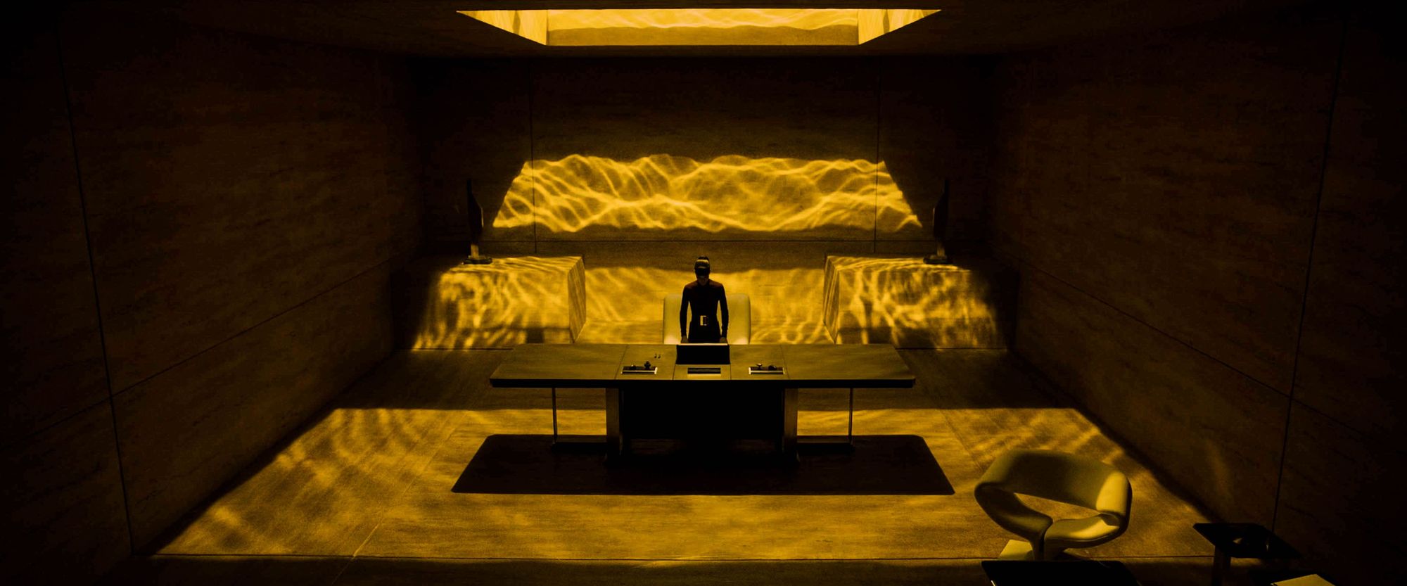 Woman standing in an office covered in yellow light