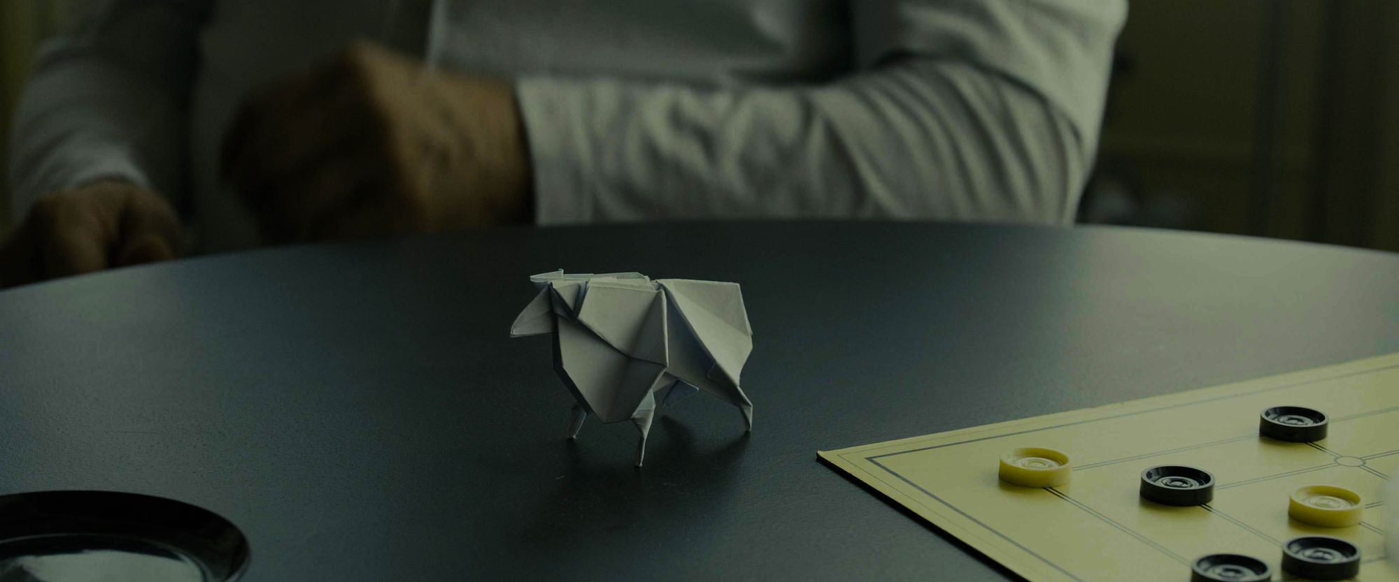 Table with a board game and origami sheep